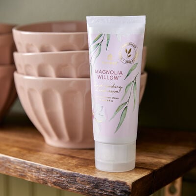 Thymes Magnolia Willow Hard-Working Hand Cream on a shelf with bowls